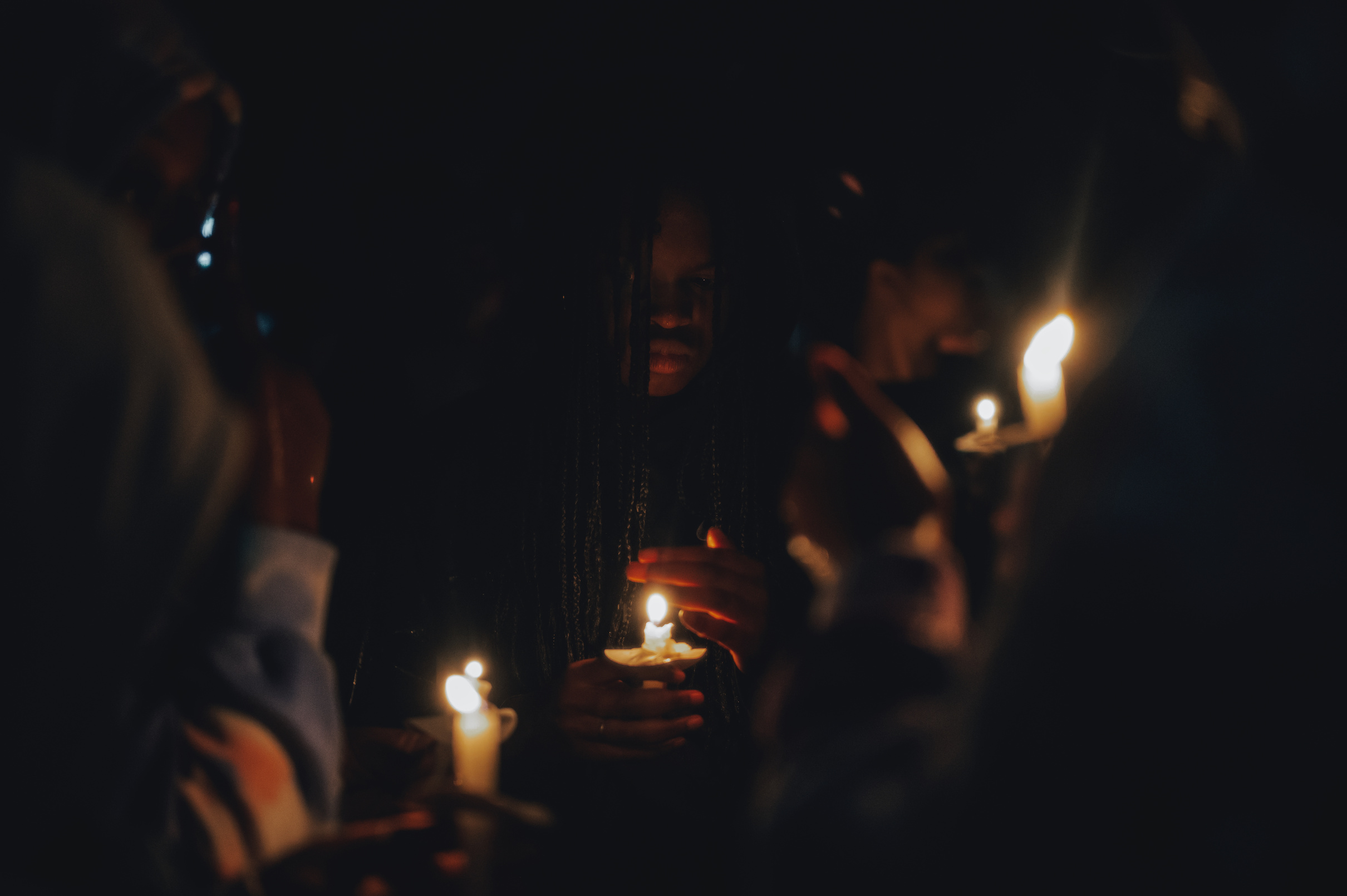 People Holding Candles during Nighttime